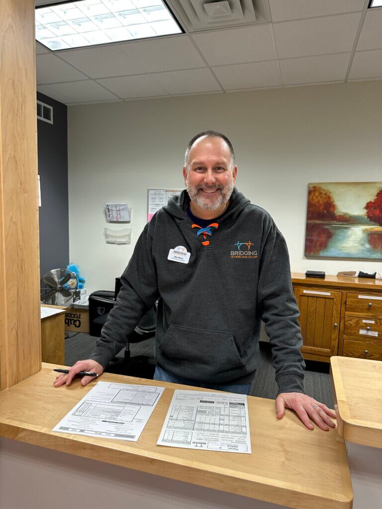 Bridging staff smiling at front desk