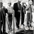 Group holding shovels into dirt at groundbreaking ceremony.