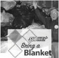 Man standing by a "Bring a Blanket" sign.